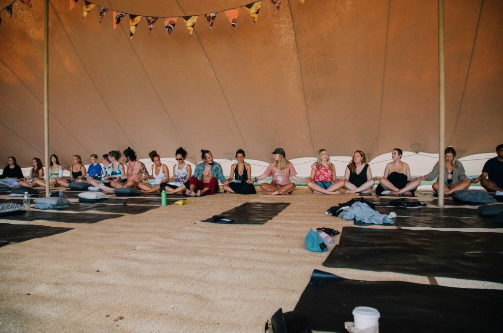 A group meditating at the lost village festival