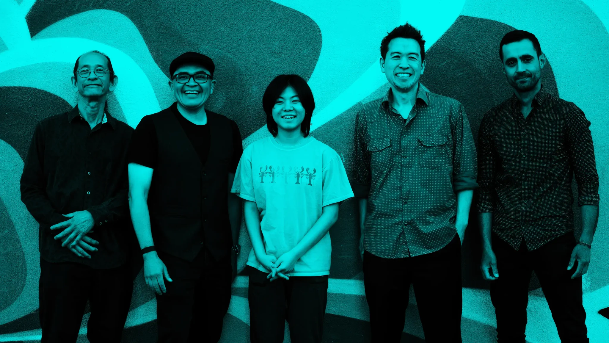Ken Okada Group ft. YOYOKA standing together in black and white against a mural wall
