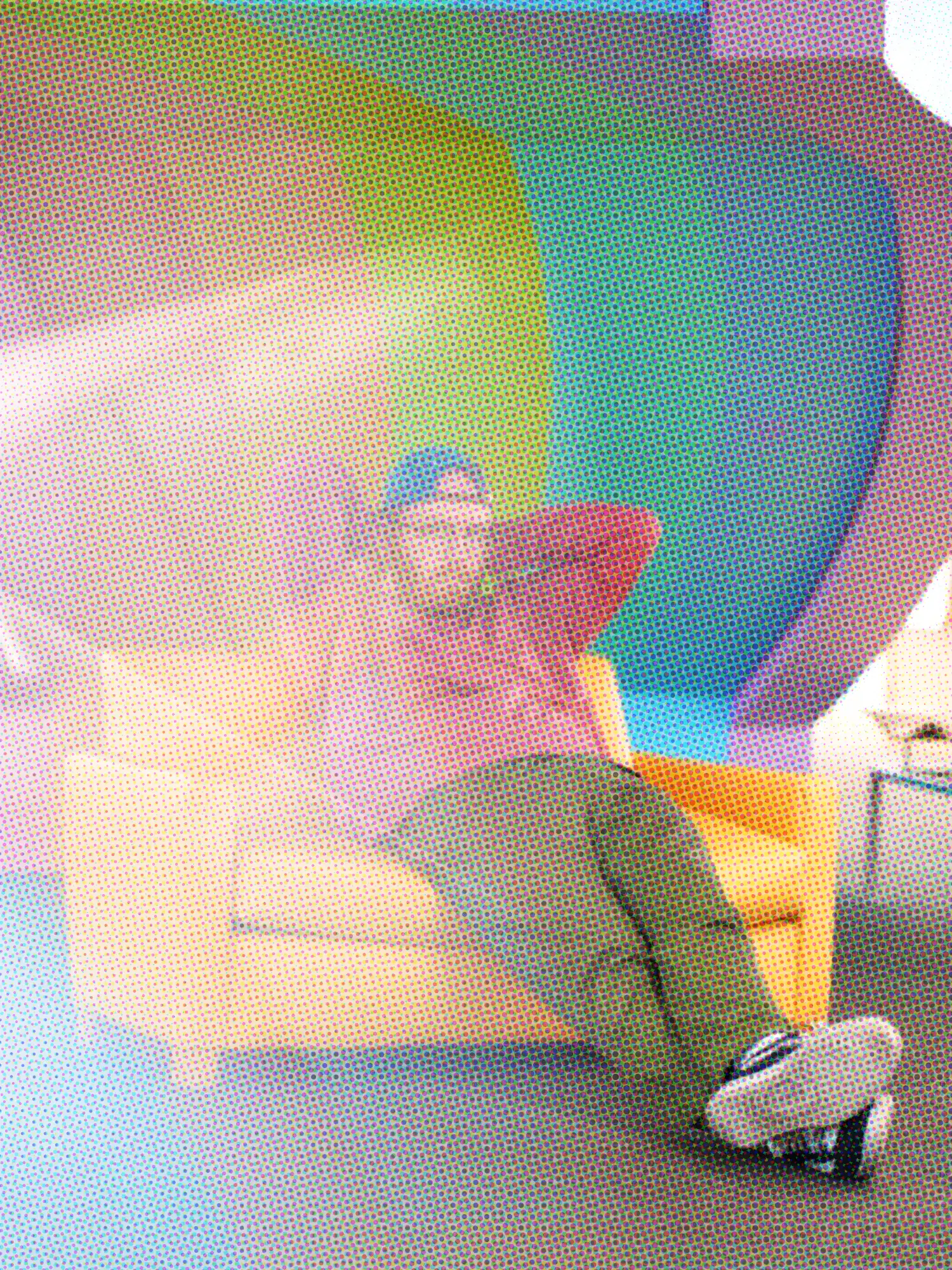 Colourful halftone-effect image of a figure walking, stylised dot pattern